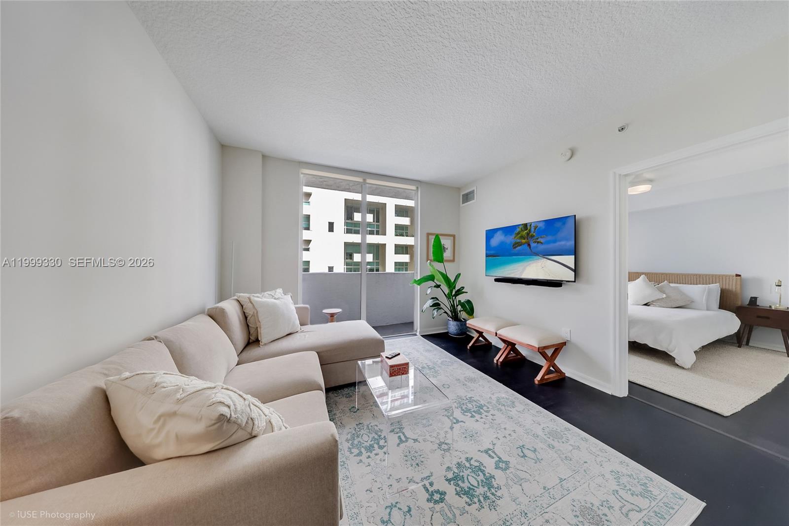 115 Southwest 11th Street, Unit 505 Miami, FL 33130 - Photo 4 of 12 a living room with furniture and a flat screen tv