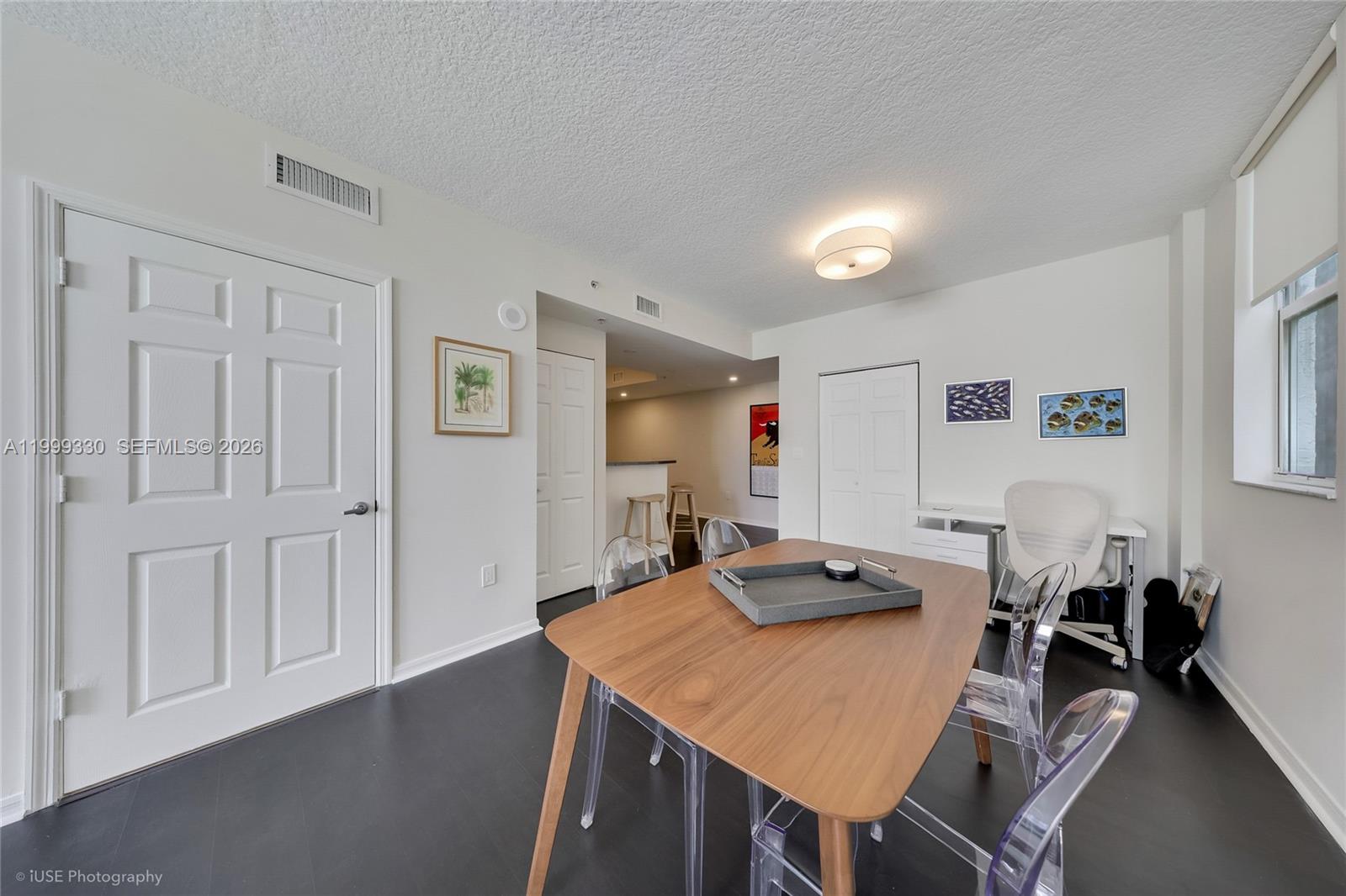 115 Southwest 11th Street, Unit 505 Miami, FL 33130 - Photo 6 of 12 a view of a dining room with furniture and a chandelier