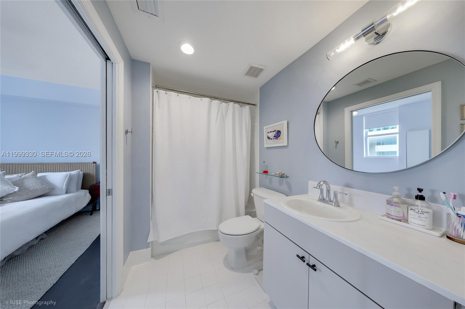 115 Southwest 11th Street, Unit 505 Miami, FL 33130 - Photo 9 of 12 a en suite bathroom with a double vanity sink toilet and a mirror