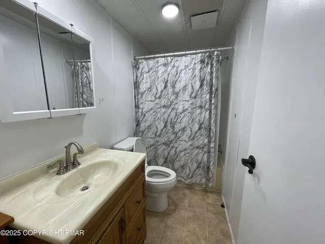 a view of a room with an empty space and a window