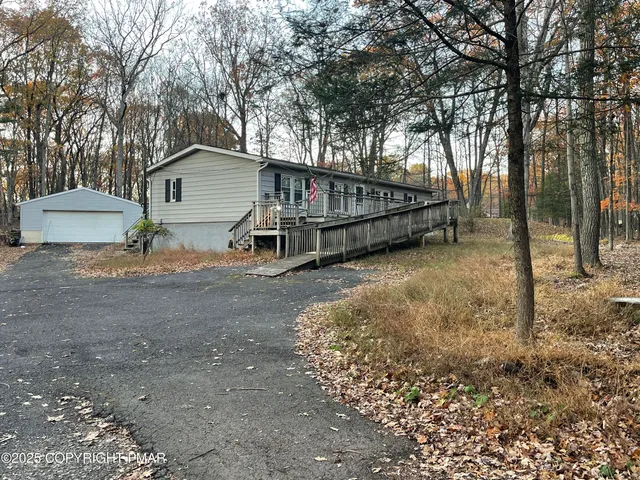 a view of a house with a yard and tree