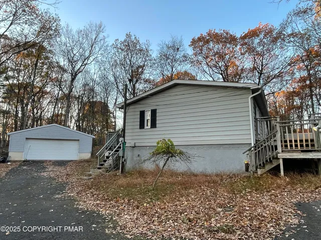 a view of a house with a yard and a patio
