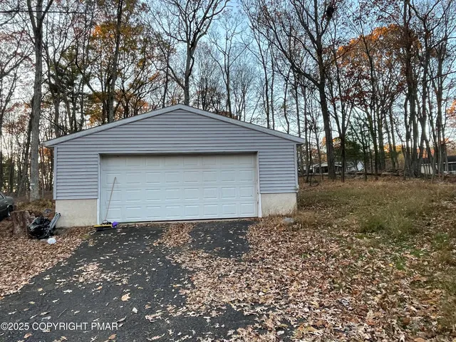 a front view of house with a garden