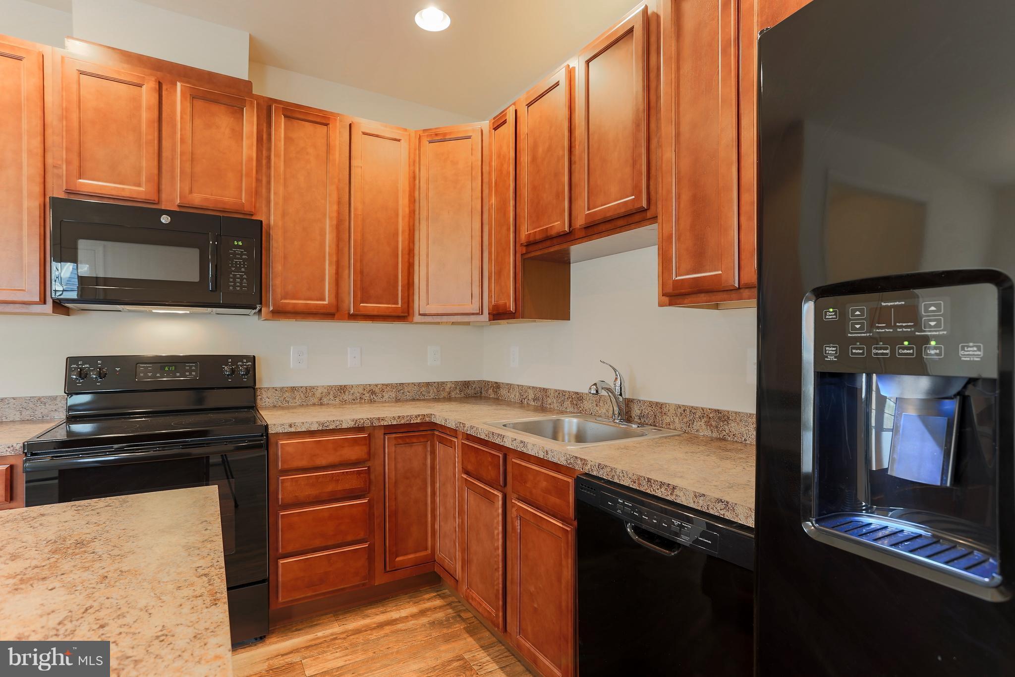 7 Back River Neck Road Baltimore, MD 21221 - Photo 29 of 29 a kitchen with stainless steel appliances granite countertop a stove top oven microwave and cabinets