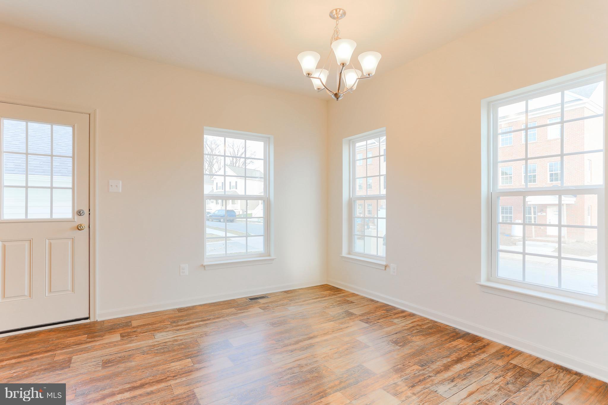 7 Back River Neck Road Baltimore, MD 21221 - Photo 4 of 29 a view of an empty room with wooden floor and a window