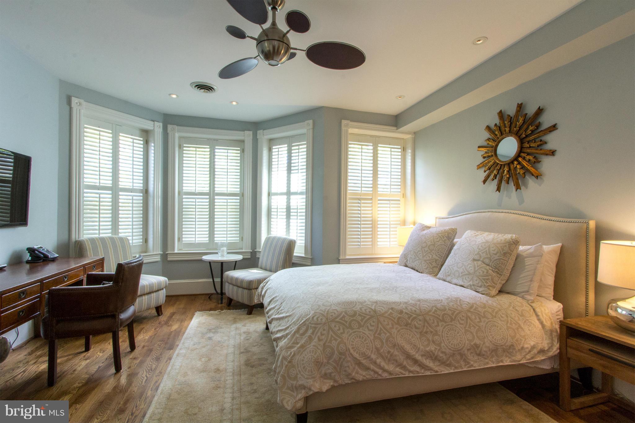 124 3rd Street Northeast Washington, DC 20002 - Photo 11 of 30 a spacious bedroom with a bed and a couch