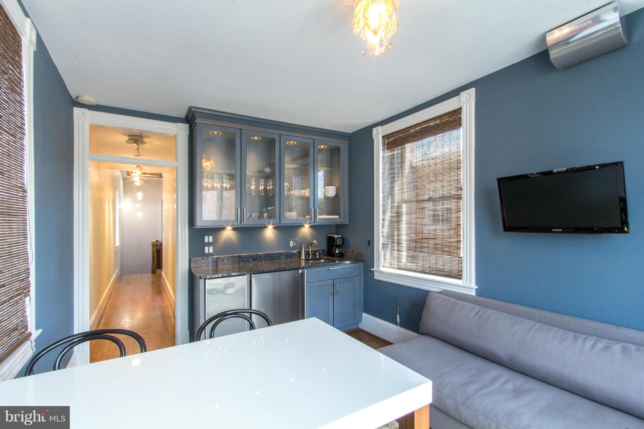 124 3rd Street Northeast Washington, DC 20002 - Photo 17 of 30 a large bedroom with a large window and a flat screen tv