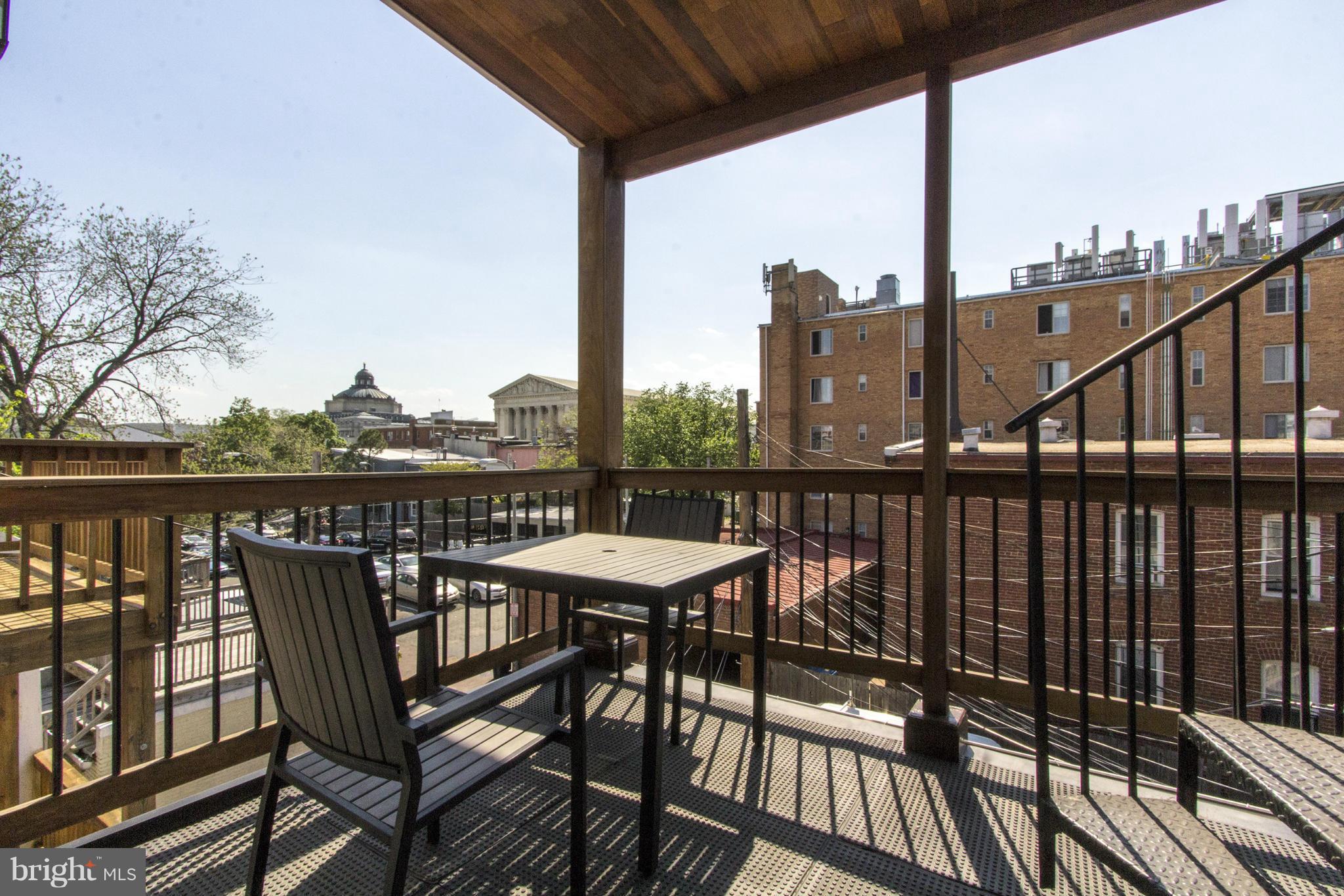 124 3rd Street Northeast Washington, DC 20002 - Photo 21 of 30 a view of a balcony with wooden floor next to a yard