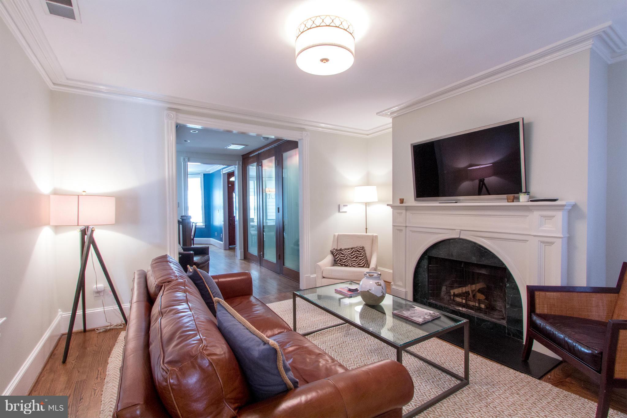 124 3rd Street Northeast Washington, DC 20002 - Photo 6 of 30 a living room with furniture a fireplace and a flat screen tv