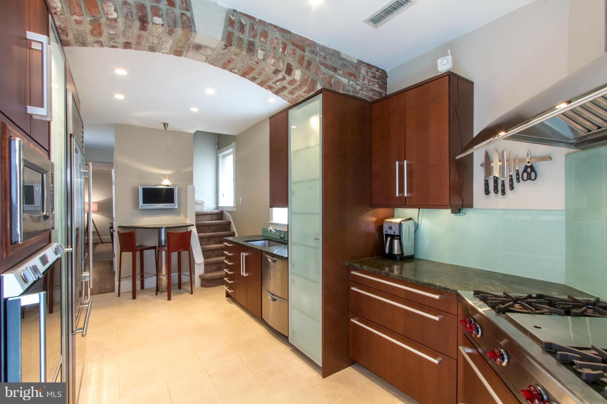 124 3rd Street Northeast Washington, DC 20002 - Photo 8 of 30 a kitchen with stainless steel appliances granite countertop a stove and a refrigerator