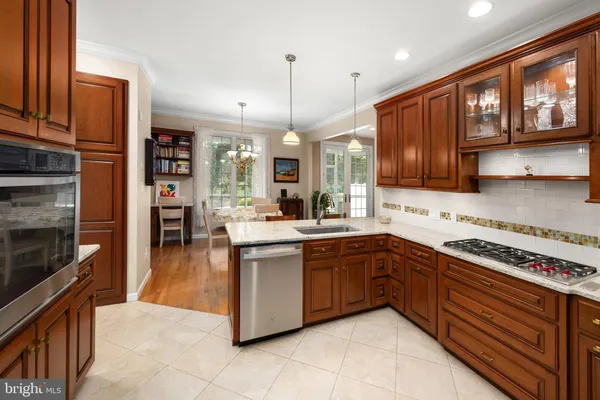 a kitchen with granite countertop a sink and a refrigerator