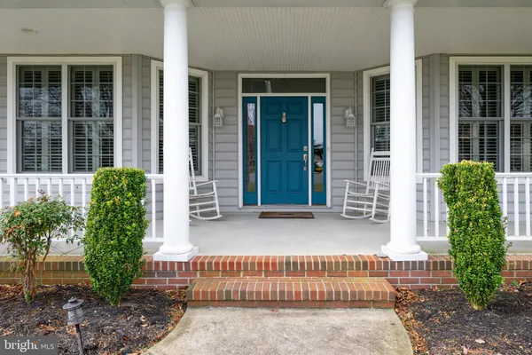 a front view of a house with a yard and outdoor seating