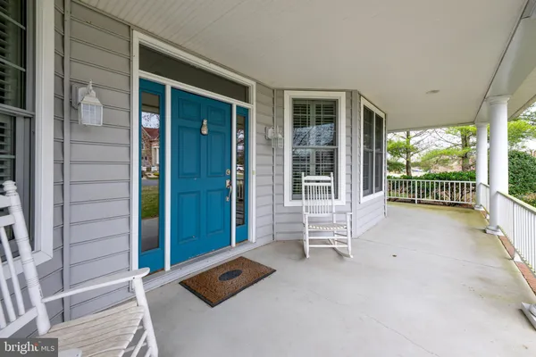 a view of an entryway with wooden floor and a livingroom
