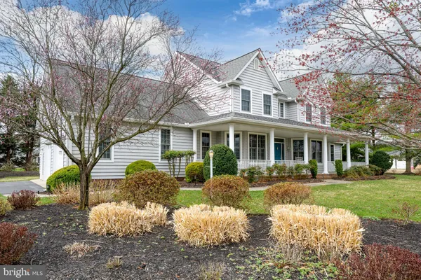 a living room with furniture a flat screen tv and a floor to ceiling window