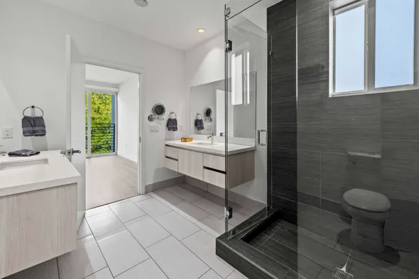 a bathroom with a sink a toilet and a shower