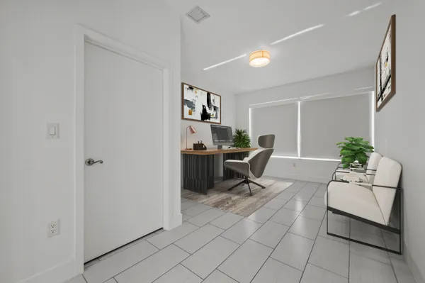 a work room with furniture and a potted plant