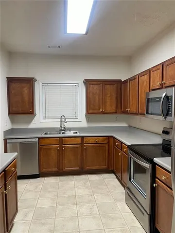 a kitchen with stainless steel appliances granite countertop a sink stove and cabinets
