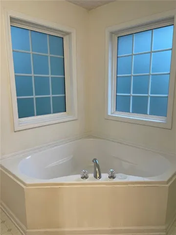 a white bath tub sitting next to a window