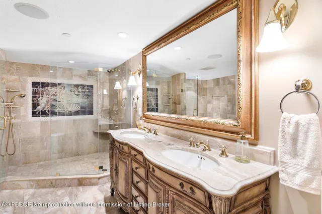 a bathroom with a tub sink and mirror