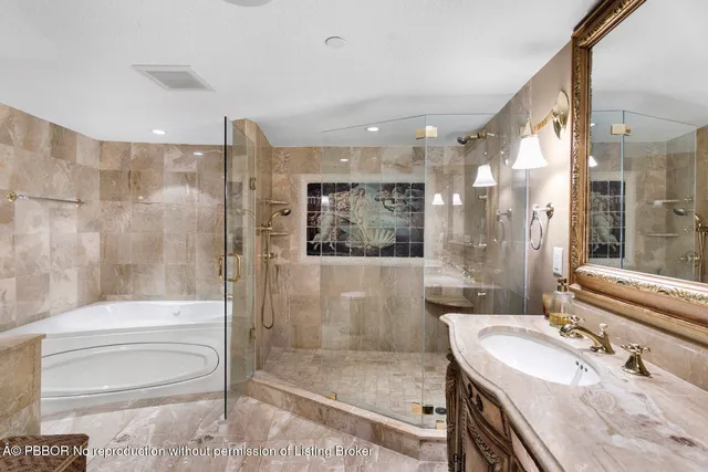 a bathroom with a granite countertop sink mirror bathtub and toilet
