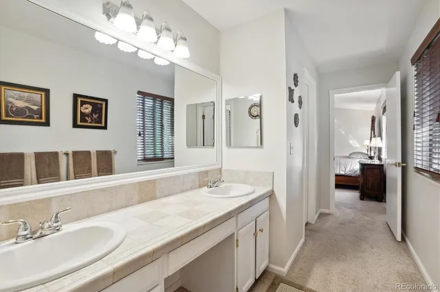 a spacious bathroom with a sink double vanity granite and a shower