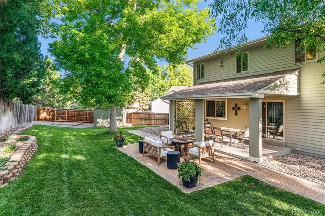 a view of a house with backyard porch and sitting area