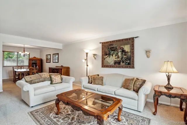 a living room with furniture and a lamp