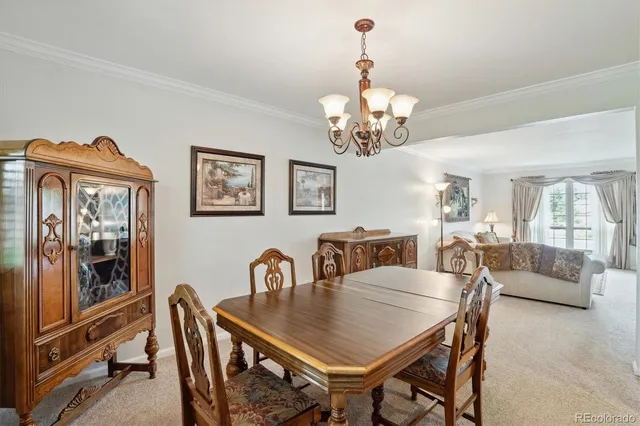 a view of a dining room with furniture wooden floor and chandelier