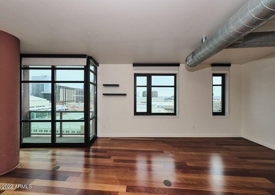 310 South 4th Street, Unit 605 Phoenix, AZ 85004 - Photo 11 of 26 a view of an empty room with wooden floor and a window