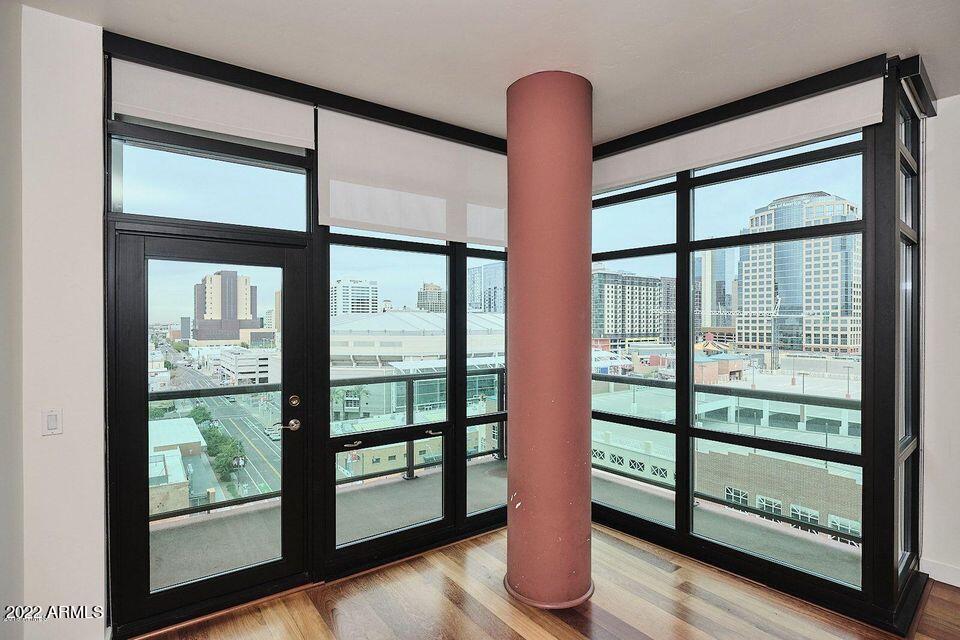 310 South 4th Street, Unit 605 Phoenix, AZ 85004 - Photo 13 of 26 a view of an empty room with wooden floor and a window