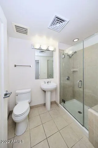 a bathroom with a toilet sink and shower