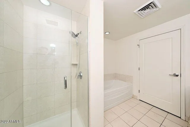 a bathroom with a bathtub and shower
