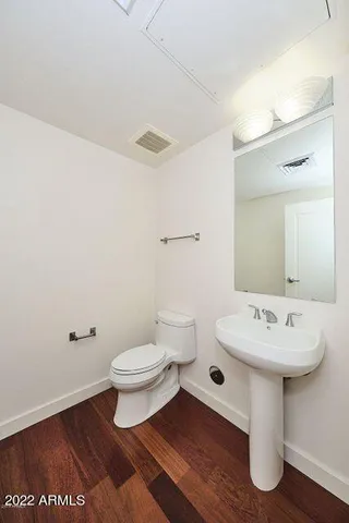 a bathroom with a sink toilet and mirror