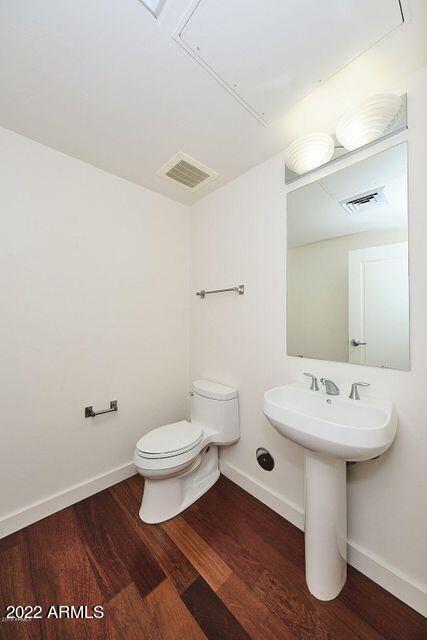 310 South 4th Street, Unit 605 Phoenix, AZ 85004 - Photo 23 of 26 a bathroom with a sink toilet and mirror