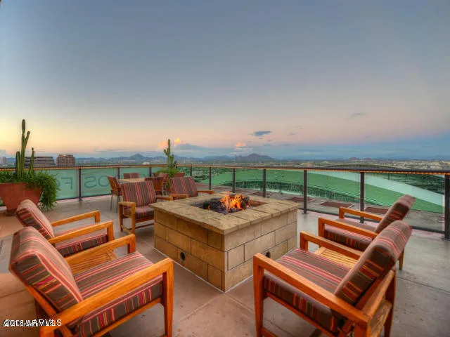 a roof deck with a table and chairs