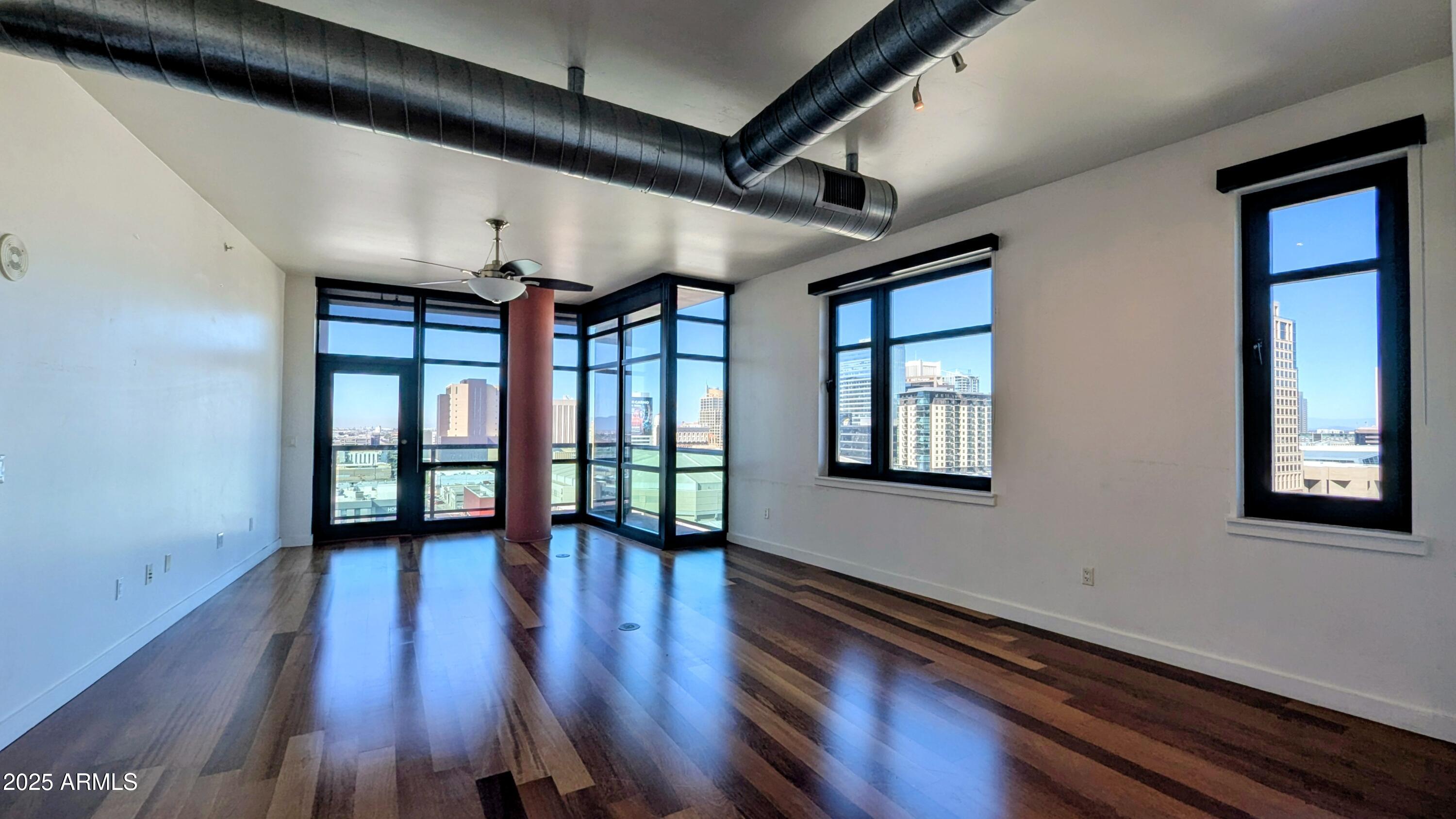 310 South 4th Street, Unit 605 Phoenix, AZ 85004 - Photo 6 of 26 a view of an entryway with wooden floor and windows