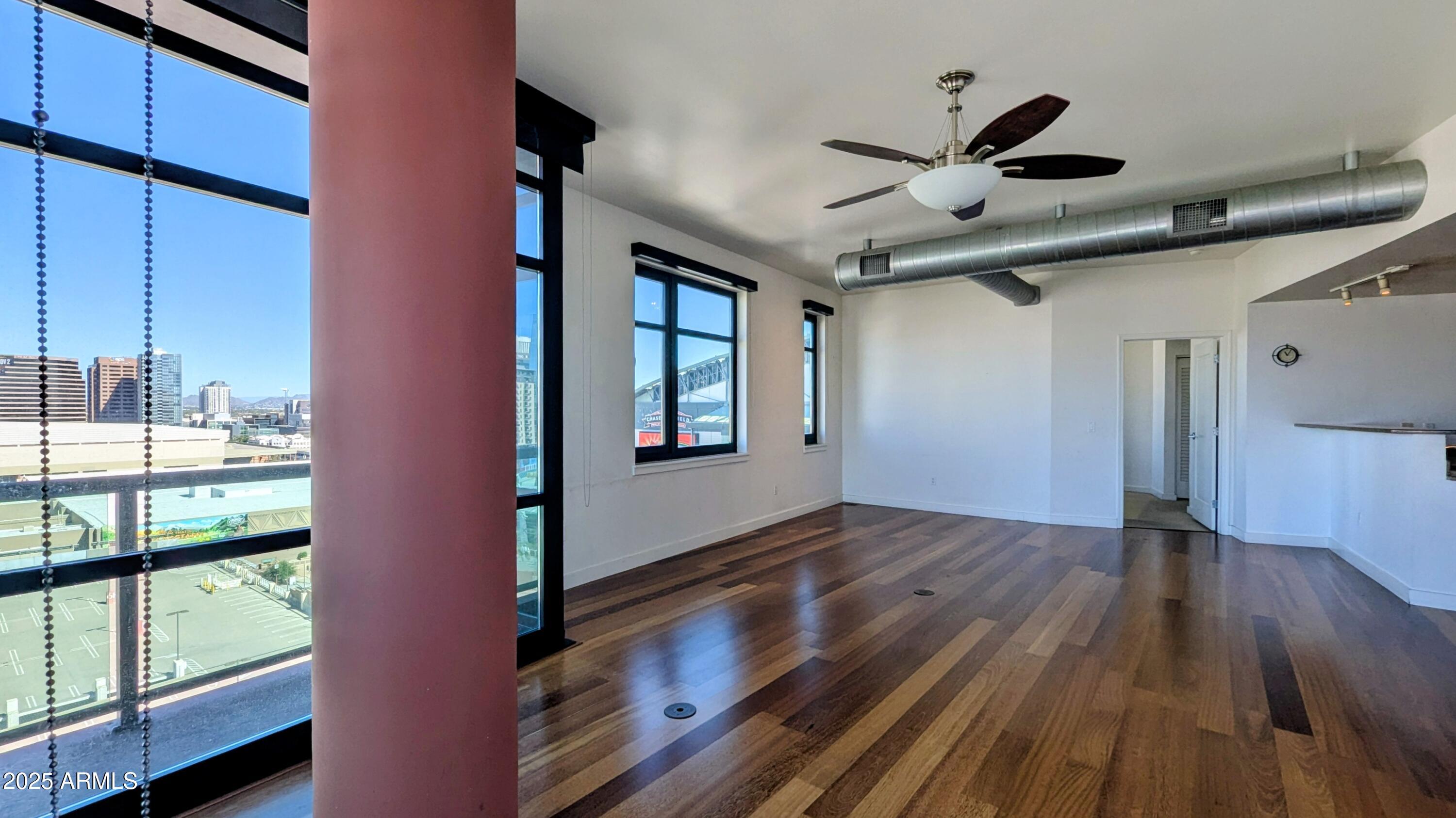 310 South 4th Street, Unit 605 Phoenix, AZ 85004 - Photo 10 of 26 a view of empty room with wooden floor and fan
