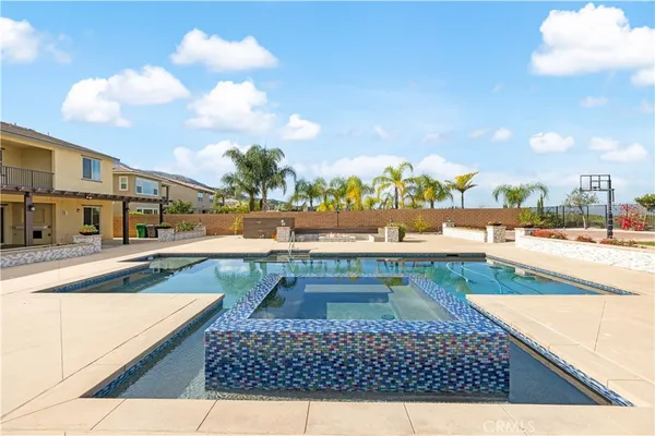 a view of swimming pool with a lounge chairs