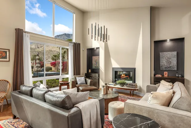 a kitchen with a stove a sink a dining table and chairs