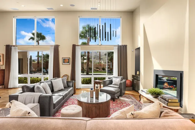 a kitchen with stainless steel appliances kitchen island granite countertop a table chairs and a refrigerator