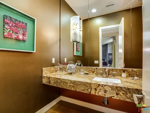 a view of a hallway with wooden floor and dining room