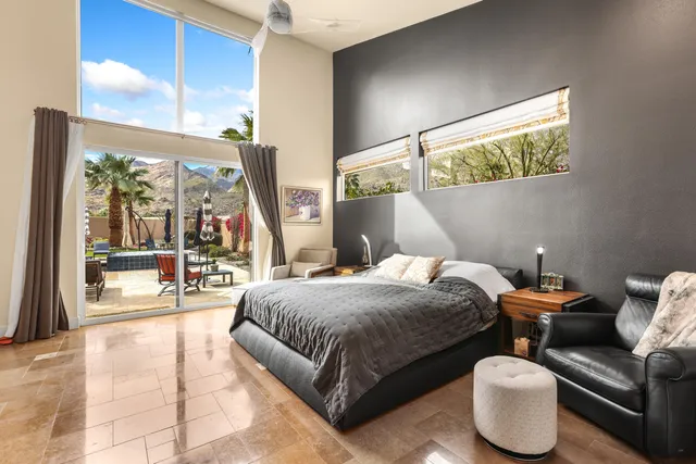 a bedroom with a large bed and a large window