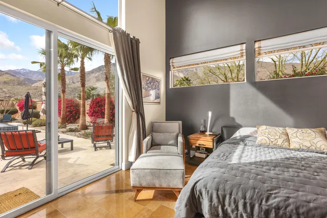 a bedroom with a bed and a large window