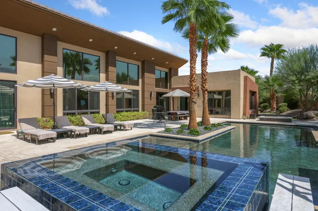 a view of house with swimming pool and porch with furniture