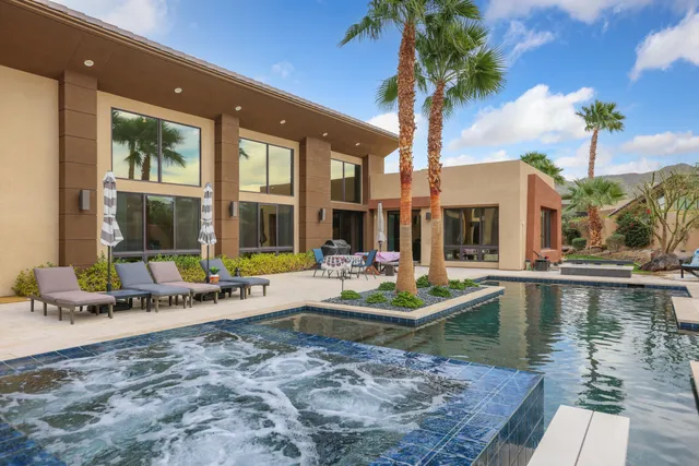 a view of a house with patio and a yard