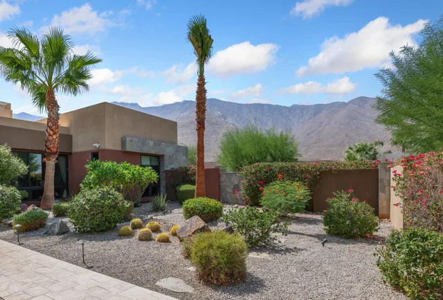 a view of a house with a yard and garden
