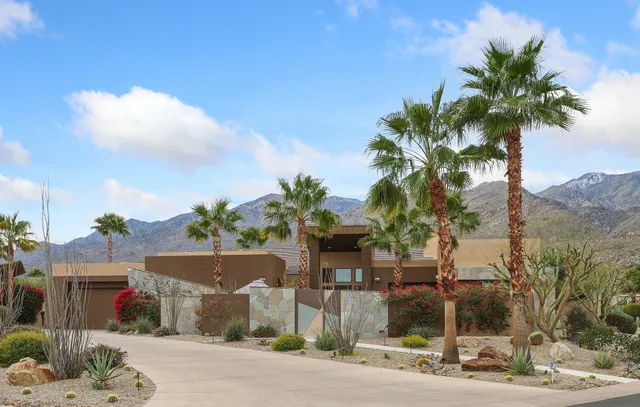 a living room with furniture fireplace and a large window