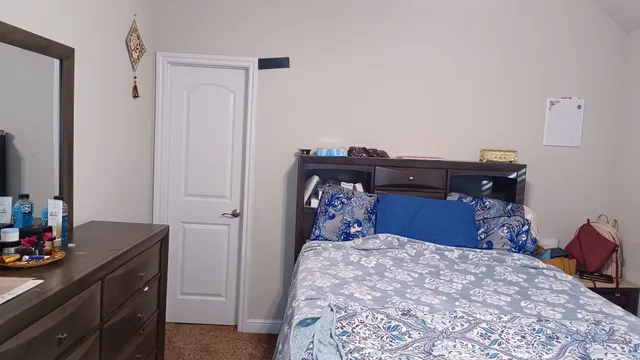 a bed room with a bed and a dresser