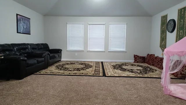 a living room with furniture window and couch