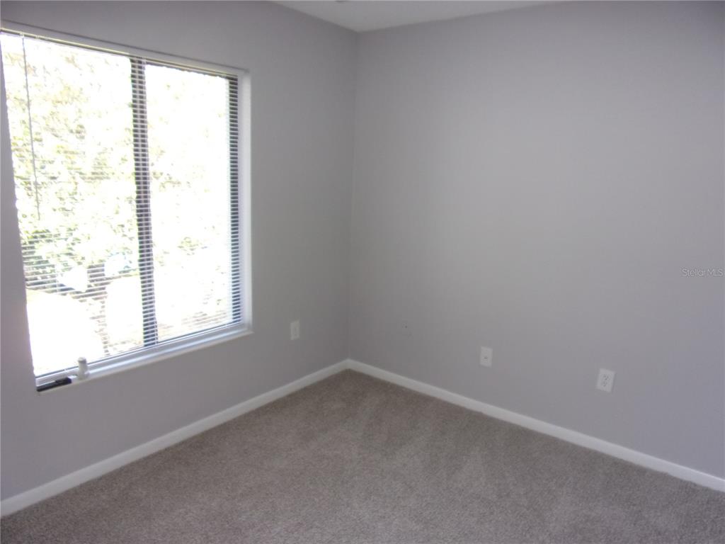 1345 Pine Ridge Circle East, Unit C2 Tarpon Springs, FL 34688 - Photo 13 of 22 an empty room with a window